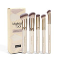 Five apricot coloured makeup brushes including angled blush brush for contouring