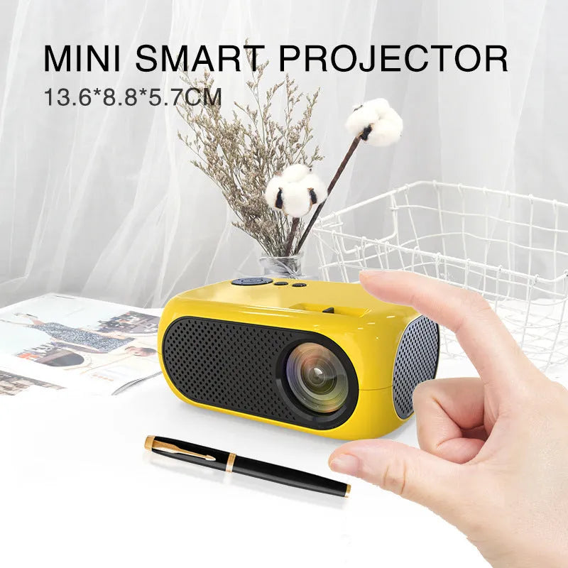 M24 micro mini portable LED projector in gold or white colour on a grey background