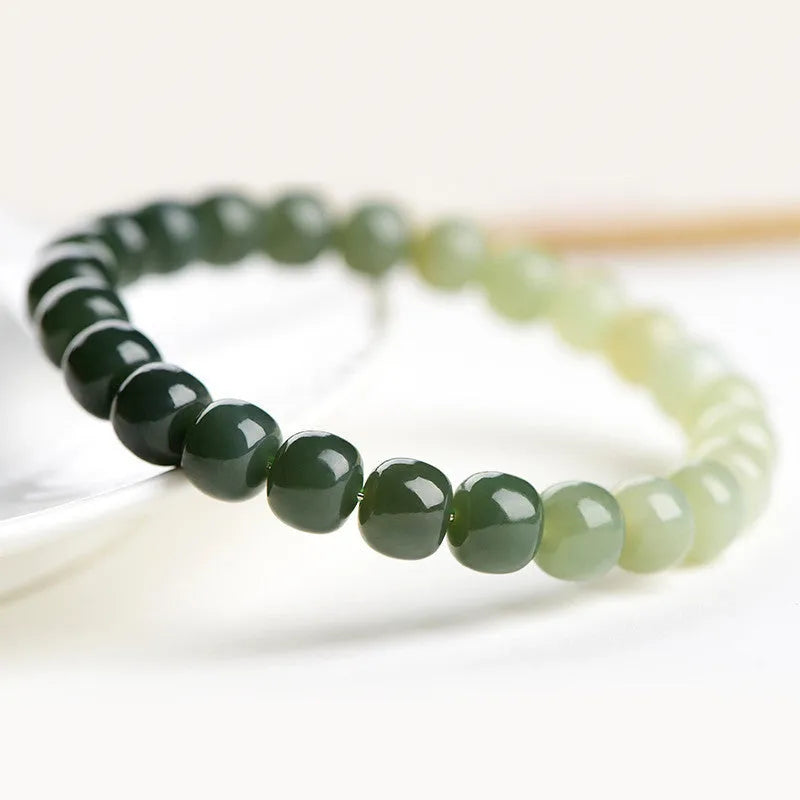 Natural Hetian jade bracelet showing water gradient colour variation on polished surface
