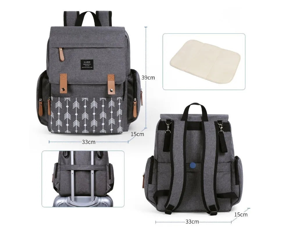 LAND Mommy large grey diaper backpack with multiple compartments and a changing mat laid out