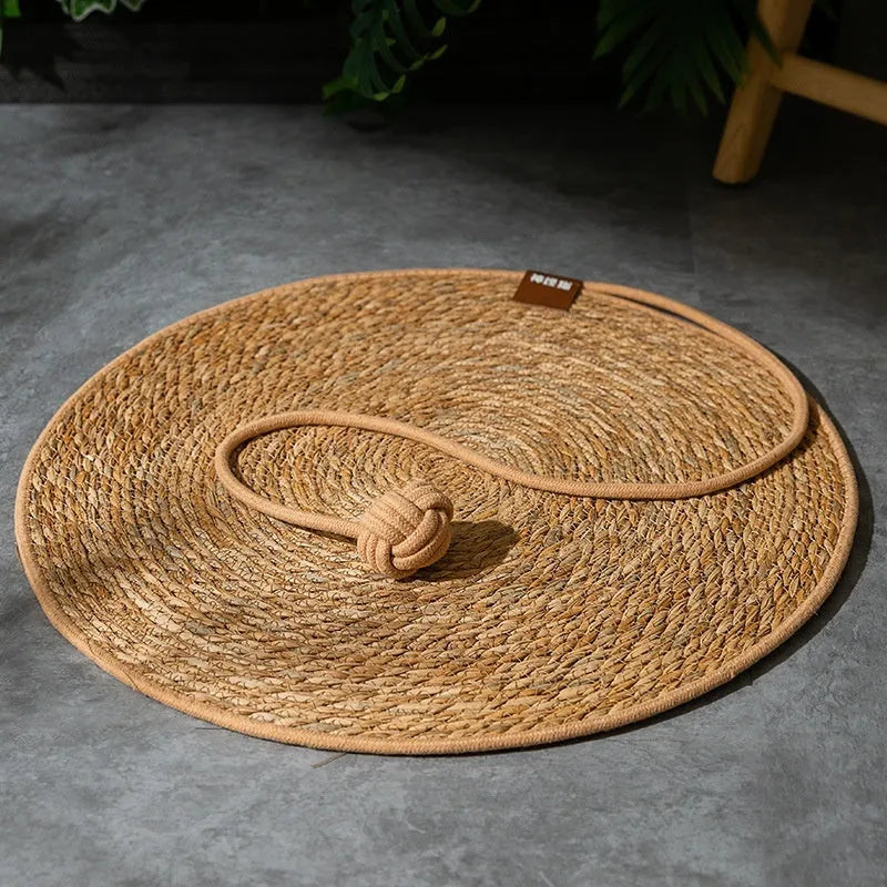 Natural papyrus round rattan cat scratching pad in winter brown colour on floor
