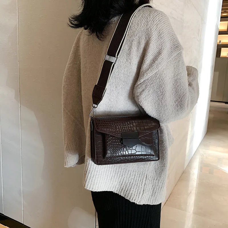 Vintage-style black PU leather crossbody bag with adjustable strap