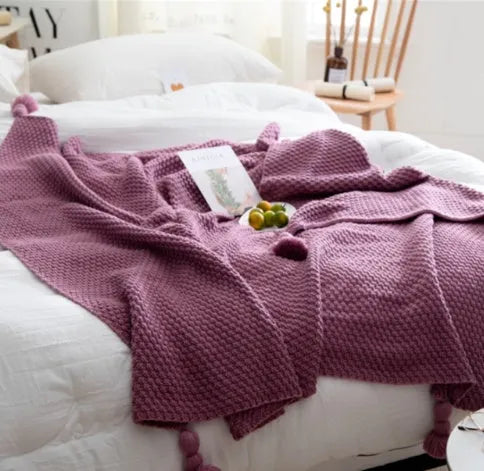 Nordic fringed knit ball acrylic blanket in beige colour on sofa