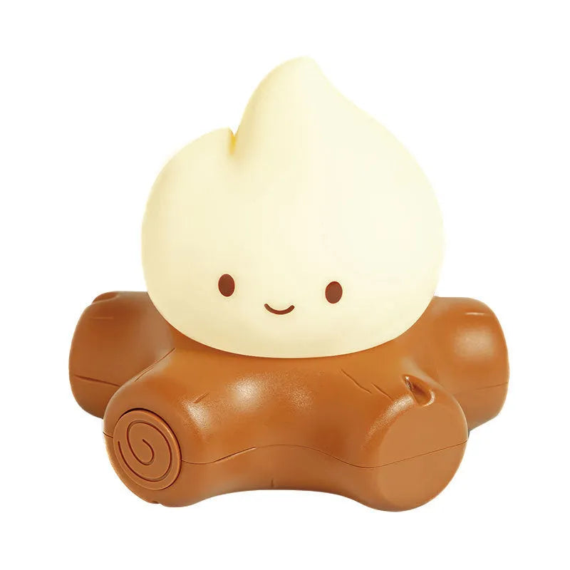 Cartoon small fire pile silicone night lamp with ABS shade on a wooden surface.