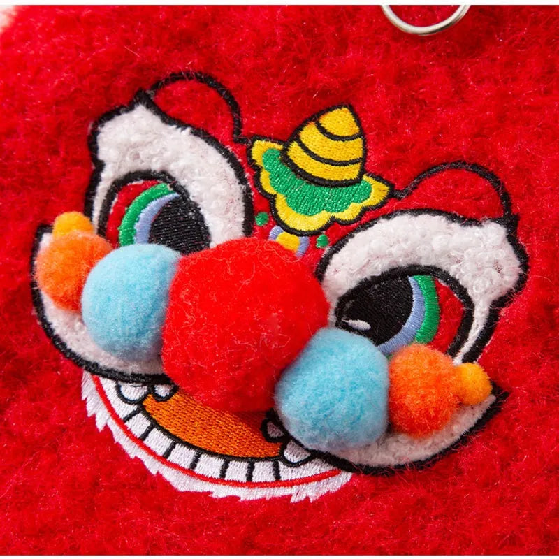 Red pet lion dance sweater with 3D face, colourful pom-poms, and leash ring on small dog