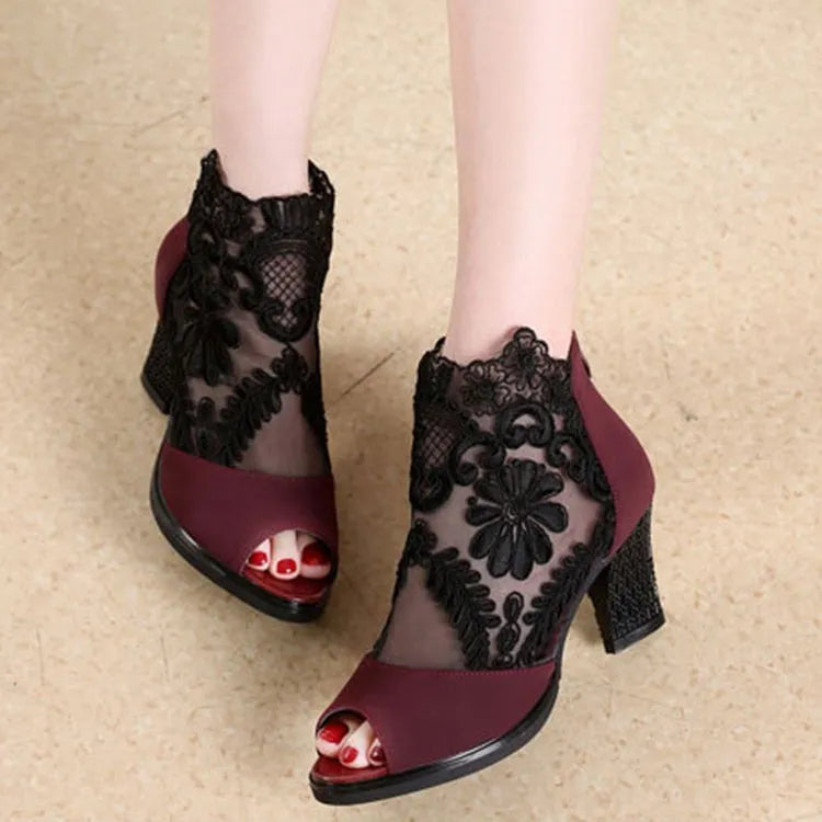 Women's black lace gladiator sandals with square heel, floral pattern, and peep toe design