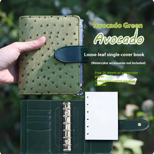 A7 format loose-leaf watercolour notebook in green, open to show removable pages suitable for painting.