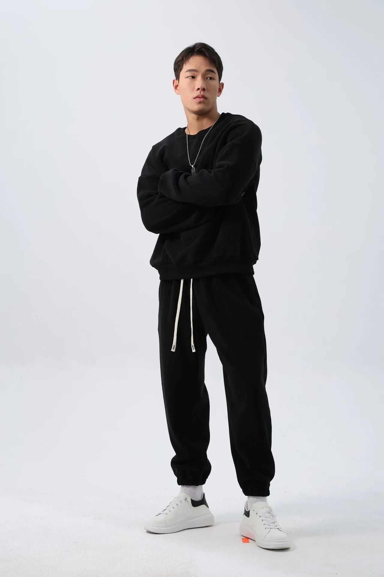 Men's polar fleece tracksuit set showing crew neck top with padded trousers in winter sportswear style