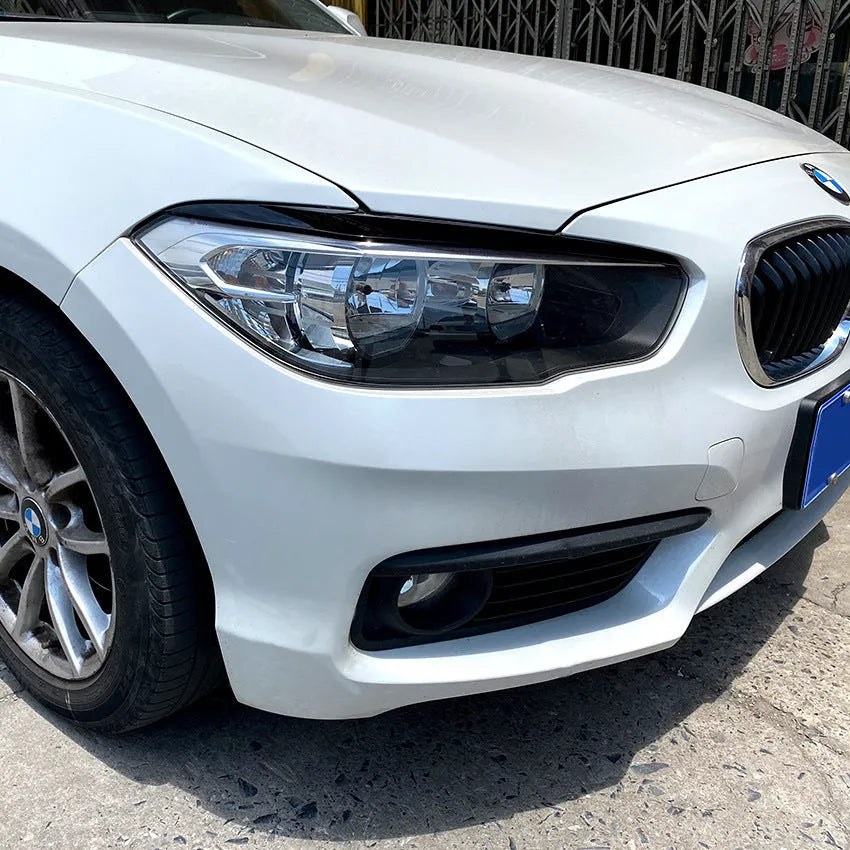 Pair of ABS headlight eyebrow stickers for BMW 1 Series F20, piano black finish, 48x8x8 cm
