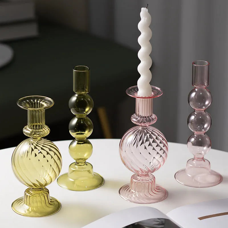 Transparent borosilicate glass three ball mott candle holder in green on a table