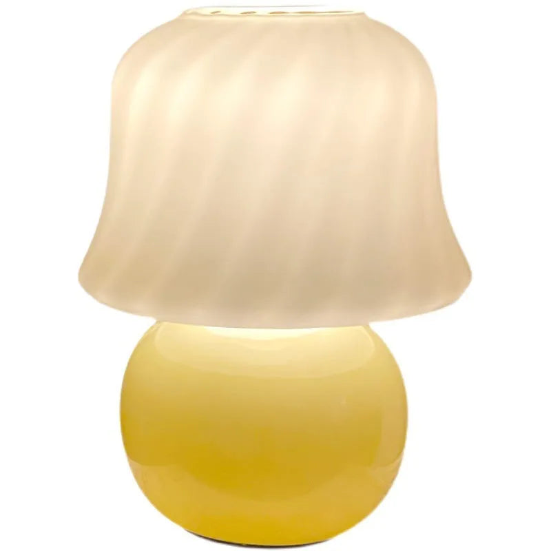 Handmade glazed glass mushroom lamp in cream yellow with push button switch on bedside table