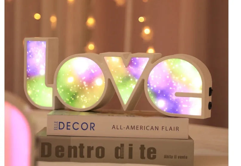 LED decorative light with rainbow-coloured LOVE word on plastic shade