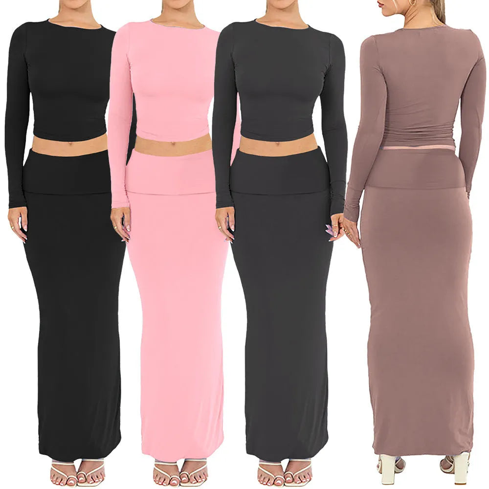 Women's black two-piece autumn suit with exposed navel top and long skirt.