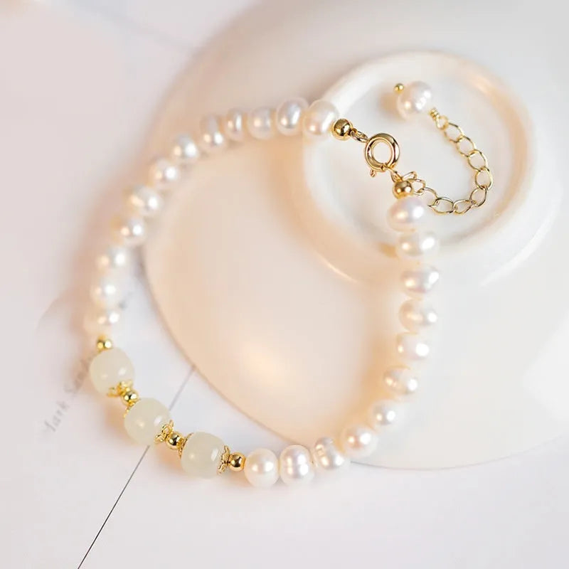 Natural freshwater pearl bracelet with diamond-shaped beads in Hetian jade colour on wrist