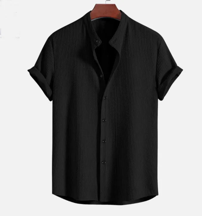 Man wearing a loose-fit short sleeve casual shirt in a solid colour, available in multiple sizes.