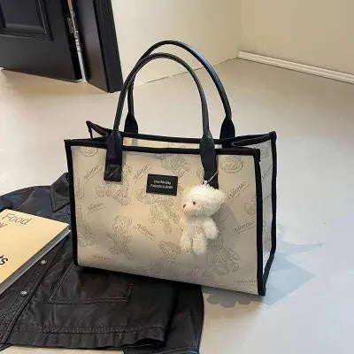 Women's black canvas tote bag with rhombus pattern showing sandwich pocket organisation interior