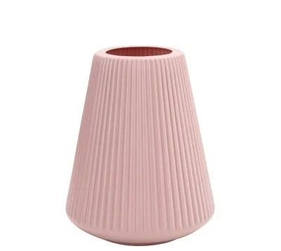 Blue melamine plastic decorative flower vase on a wooden desktop.
