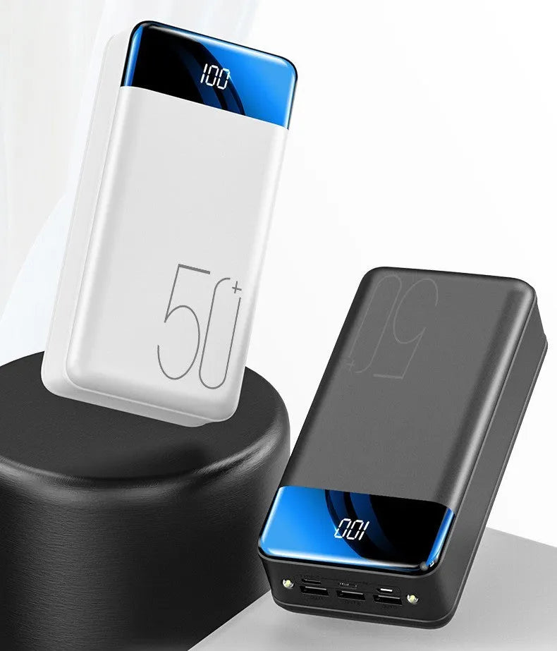 Black and white large capacity 50000mAh power bank with multiple USB ports for charging.