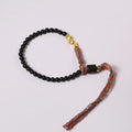 Hand-woven obsidian carrying strap bracelet with a stone bead, showing its 4mm width and adjustable length.