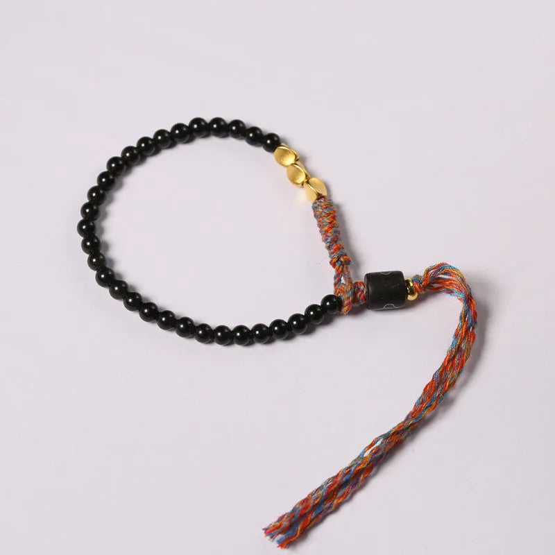 Hand-woven obsidian carrying strap bracelet with a stone bead, showing its 4mm width and adjustable length.