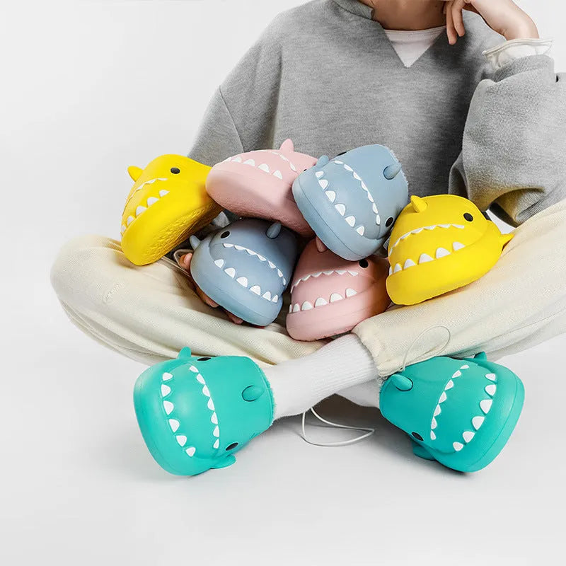 Winter soft bottom household couple EVA cartoon shark cotton slippers in blue, grey, pink on a floor