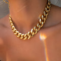 Women's gold coloured thick chain alloy necklace showing 32cm length and 6cm wide links.