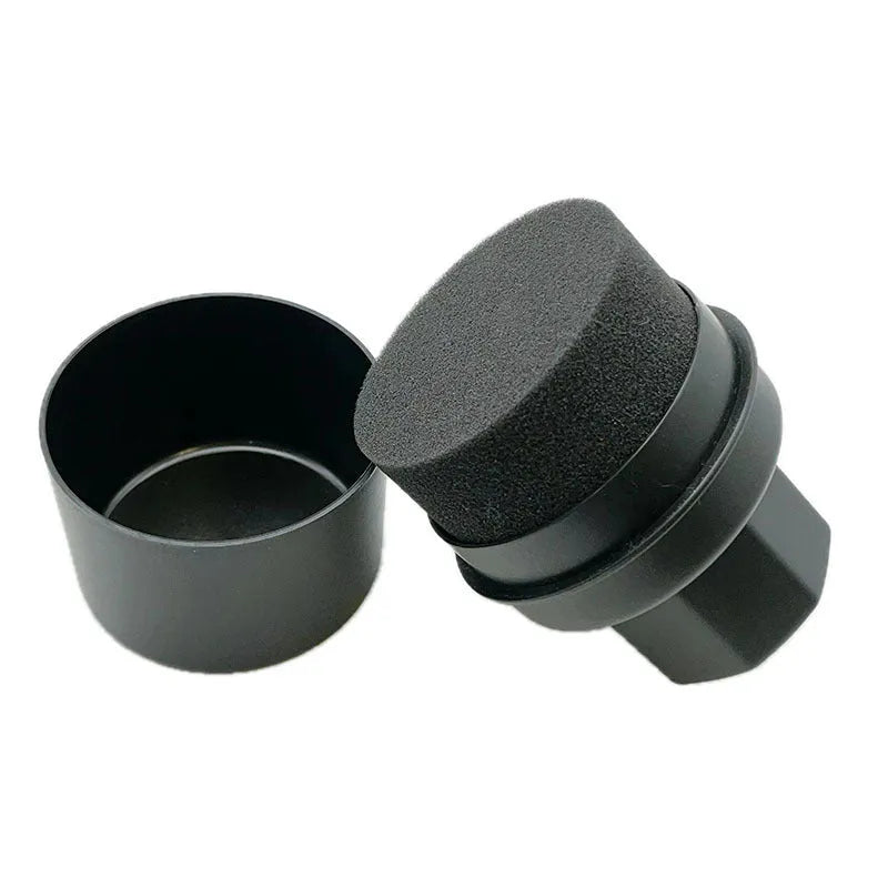 Black and red car tyre polishing sponge brushes with lids on a tyre sidewall