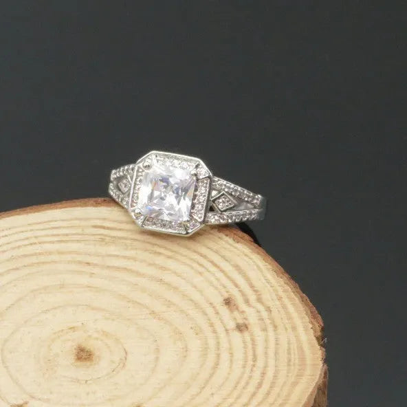 Geometric hollow zircon ring in platinum colour with four-sided design on woman's finger