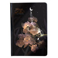 A5 scrapbook notebook with luminous cover open to show colour illustration pages, in purple colour option.
