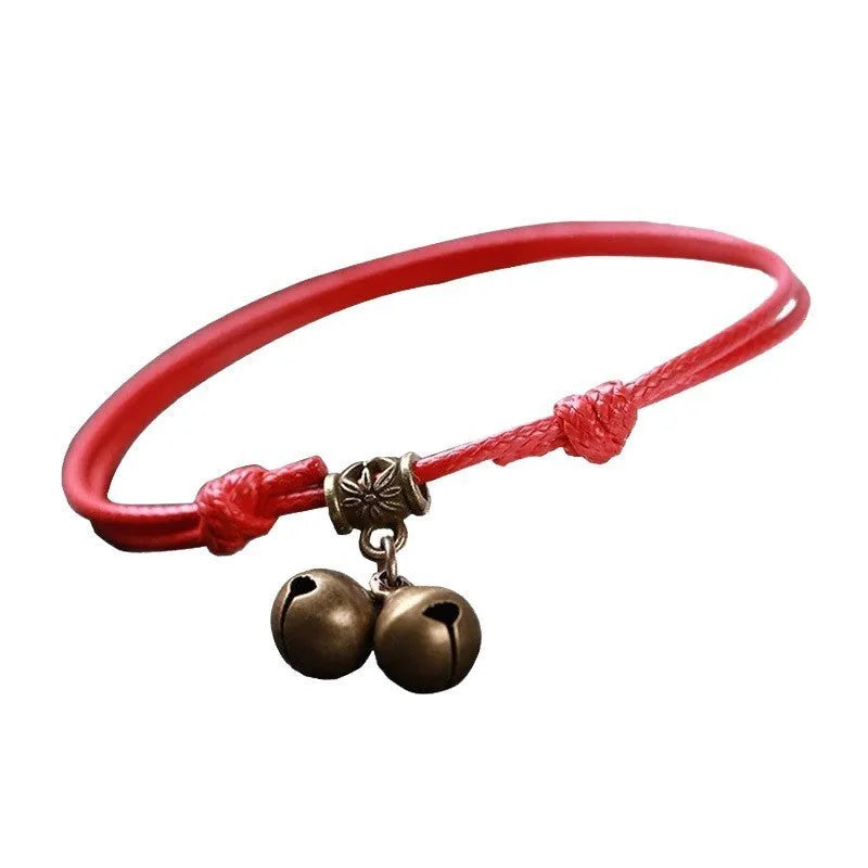 Adjustable nylon dog collar with brass bell, shown in black rope colour on a size chart.