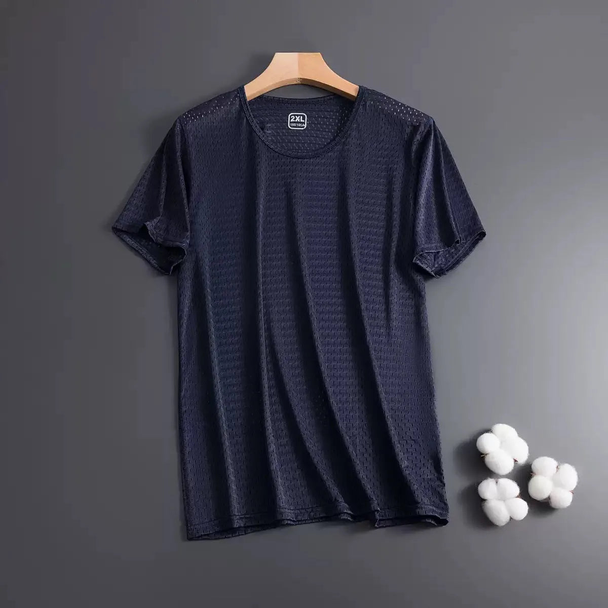 Men's solid colour ice silk short sleeve t-shirt on a hanger, showing loose crew neck and thin mesh fabric.
