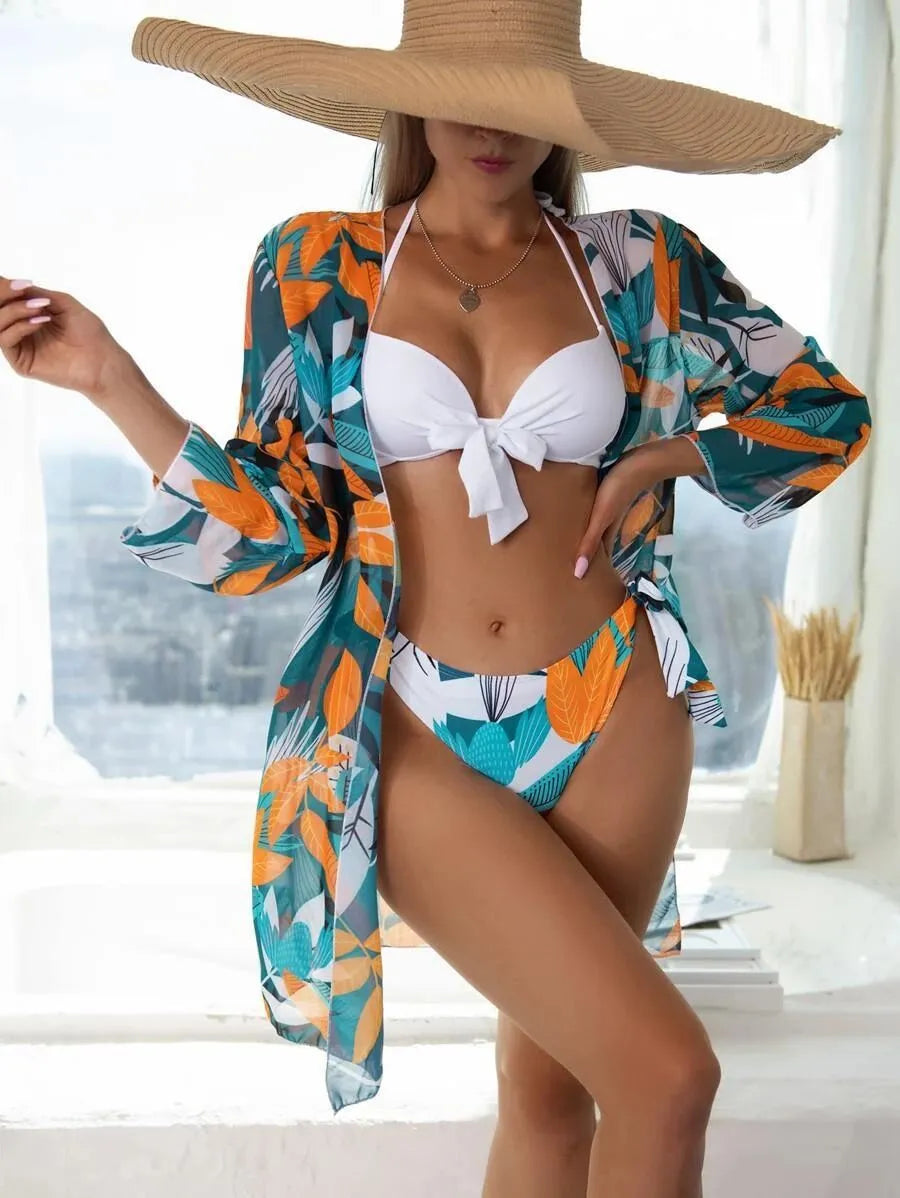 Women's three-piece bikini swimsuit set with mesh split detail in polyester fabric.
