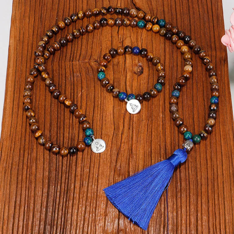 Handmade tiger eye stone bead necklace with tassel pendant and matching bracelet on a neutral background