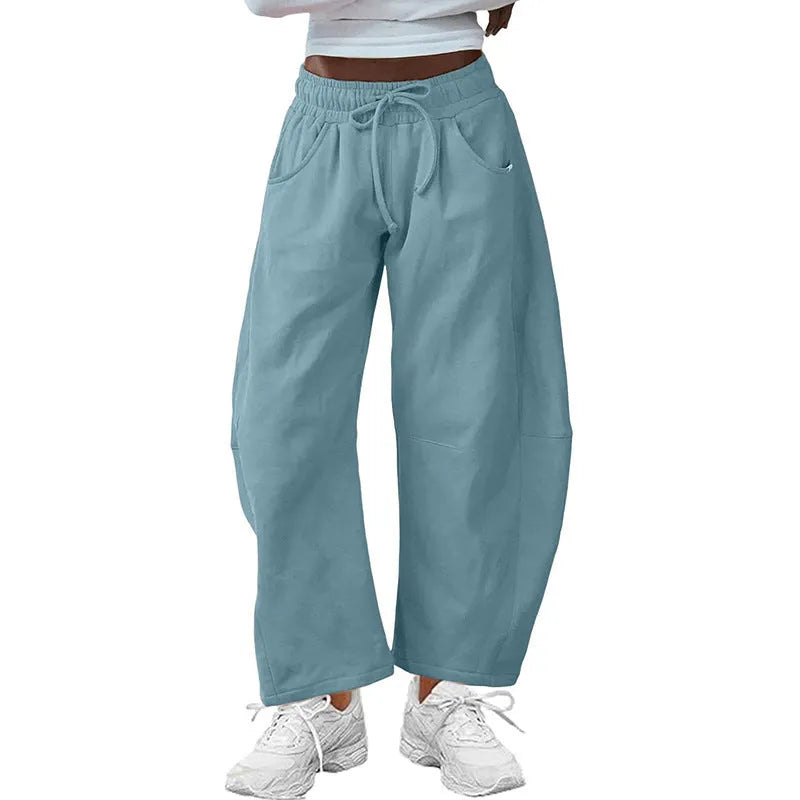 Women's loose cropped sweatpants with drawstring elastic waist and side pockets in street fashion style