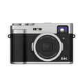 Black and brown 5K digital camera with dual lenses and an optical viewfinder on a 2.88-inch screen.