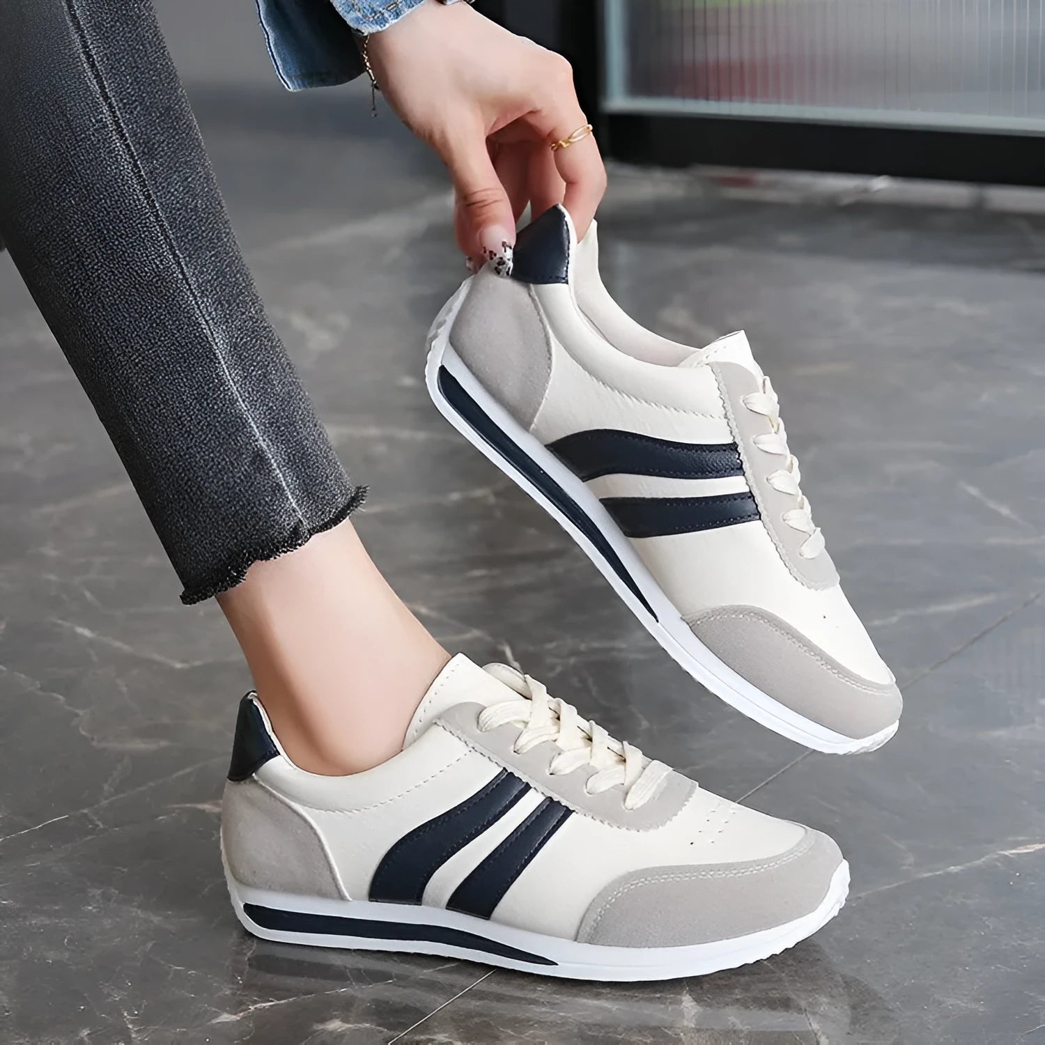 Red low-top lace-up running sneaker with round toe and rubber sole.