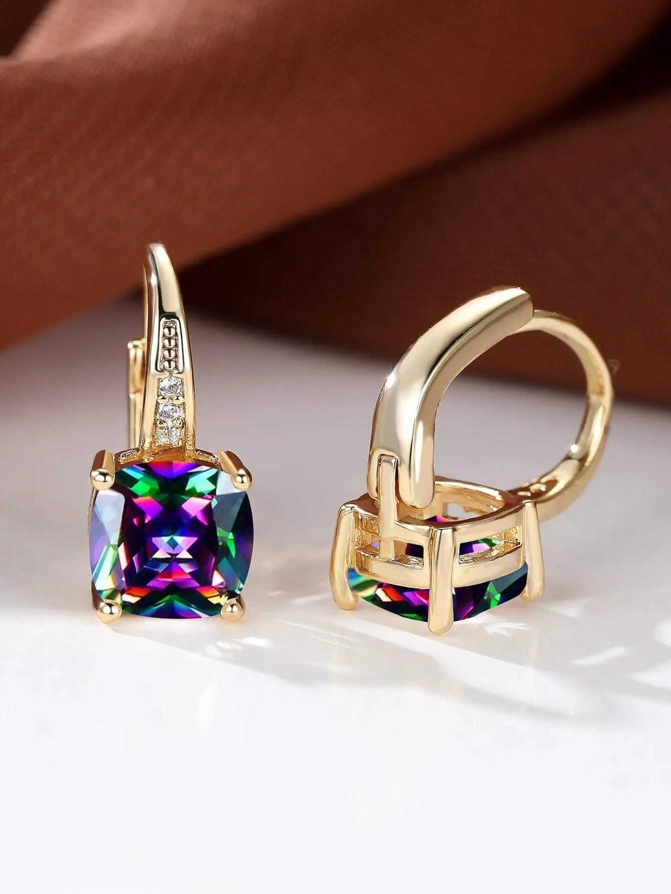 Square geometric ear clip with colourful moissanite inlay on an electroplated copper base.