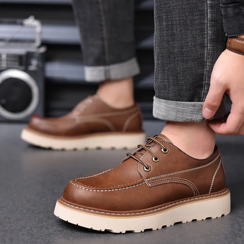 Men's black retro Martin boots with round toe and rubber sole showing height-increasing mid heel