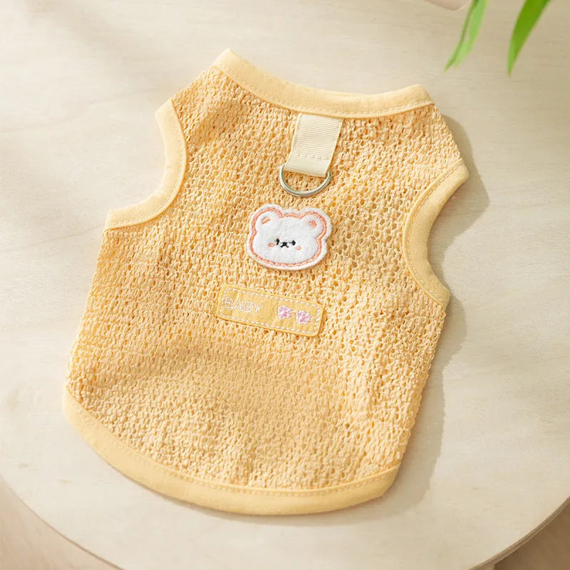 Hollowed-out cat clothes with bear patch in blue, green, yellow colours showing knitted fabric texture