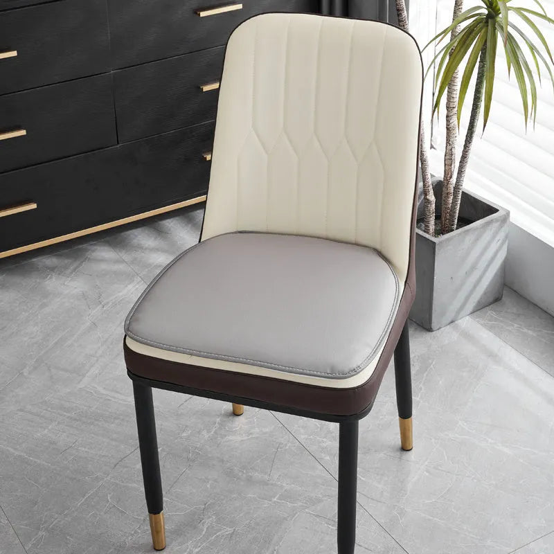 Leather horseshoe-shaped seat cushion in beige colour on a wooden chair, showing non-slip base.