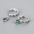 Women's zircon earrings with heart-shaped drops in gold or white gold settings with coloured gemstones