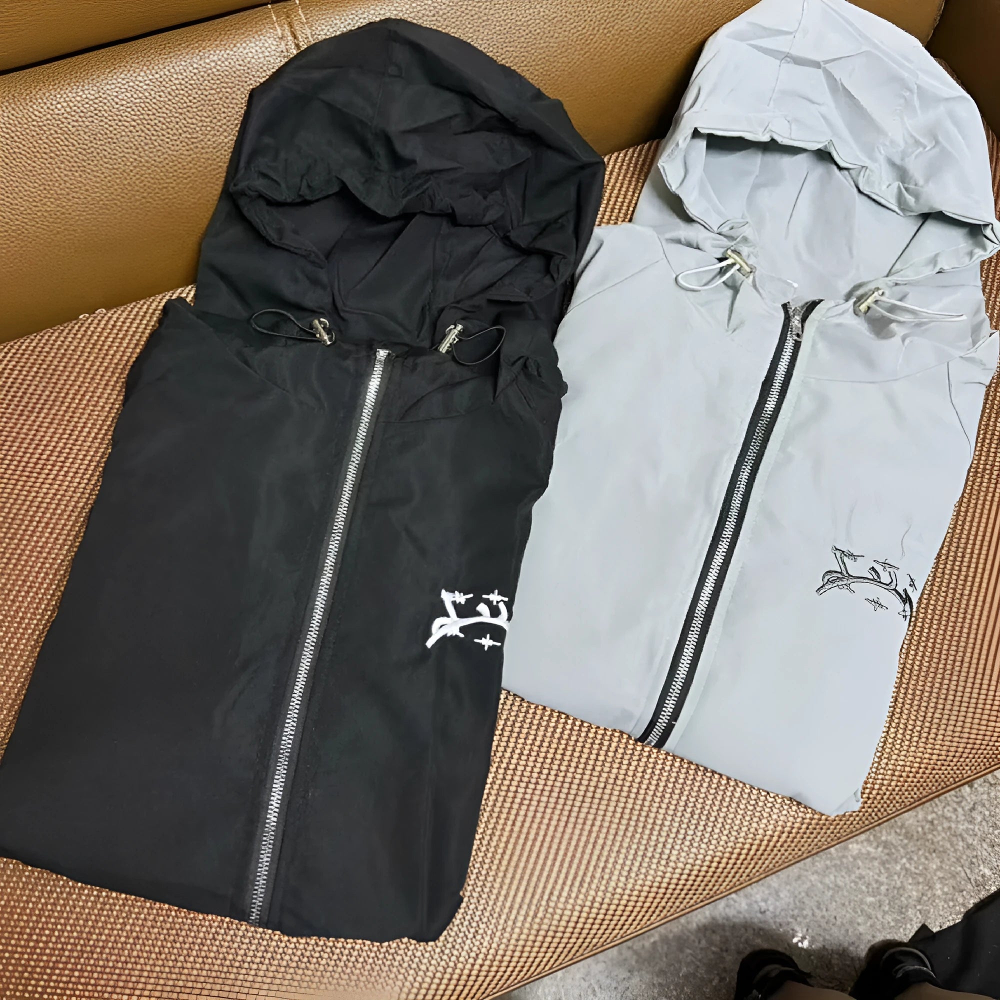 Man wearing a grey loose-fit hooded sunscreen jacket in British style.