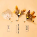Three steel wire cat toy replacement heads with small flying insect designs in different colours.