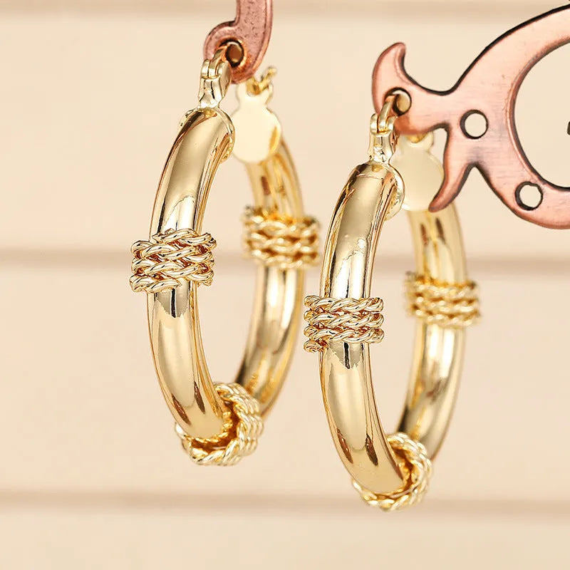 Geometric copper women's earrings with ring and line elements in golden colour