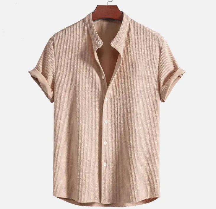 Man wearing a loose-fit short sleeve casual shirt in a solid colour, available in multiple sizes.