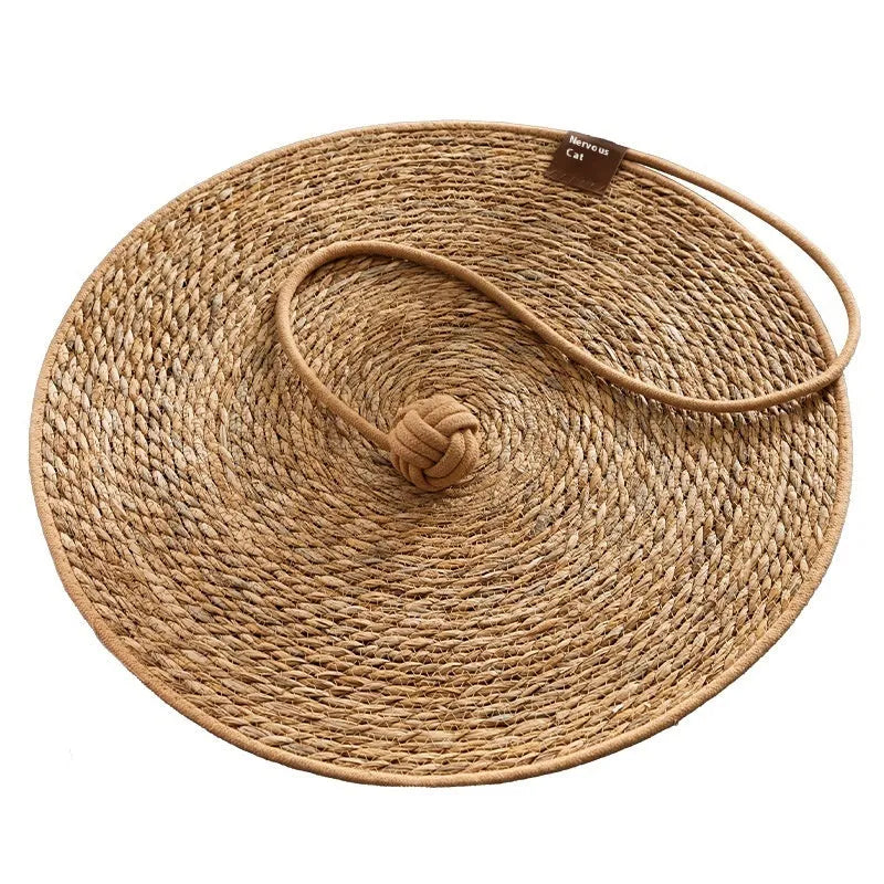 Natural papyrus round rattan cat scratching pad in winter brown colour on floor