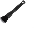 Black ultra-soft pig hair car detailing brush for interior cleaning on a car dashboard.