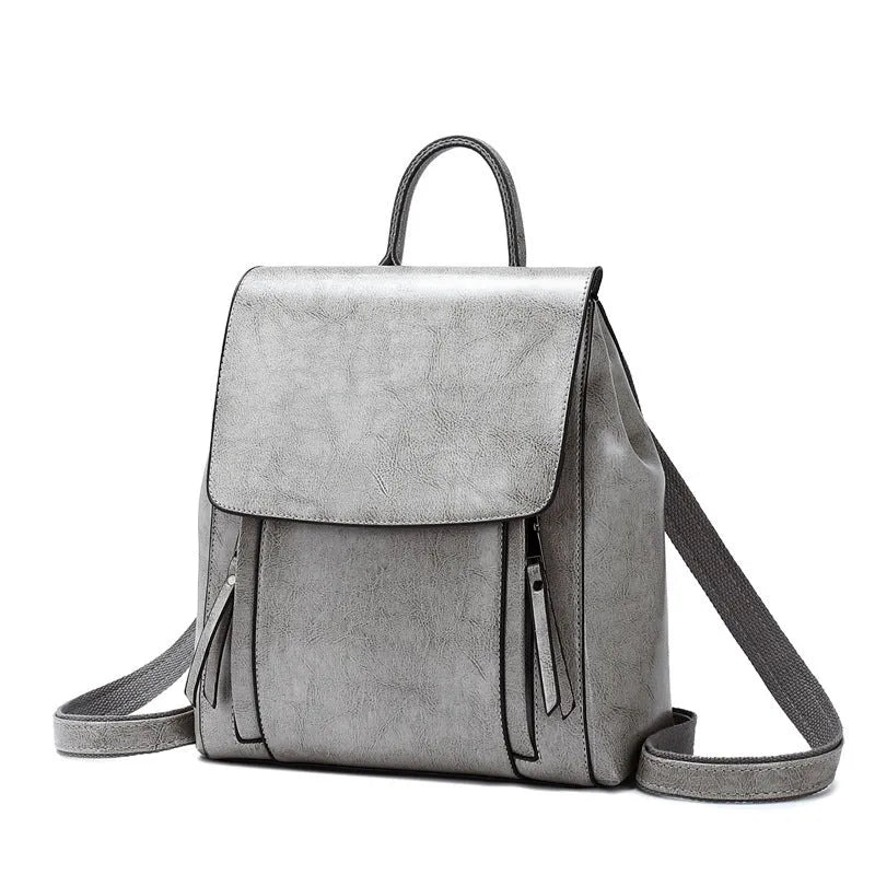 Genuine leather women's backpack in square vertical shape with double straps and stitching detail.