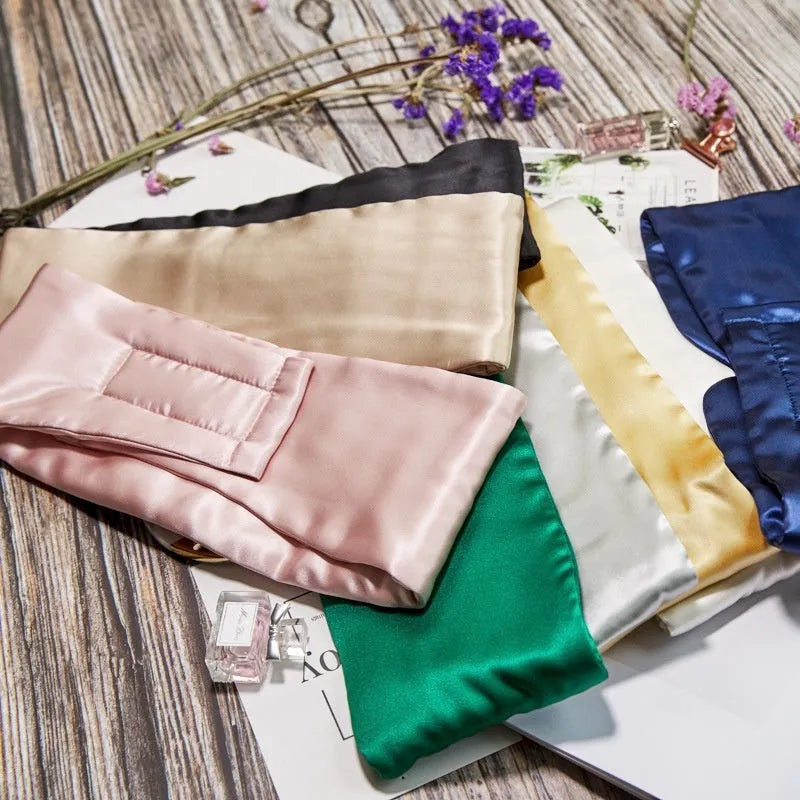 Mulberry silk sleep eye mask in multiple colours including black, gold, green, blue, pink, grey, and white.