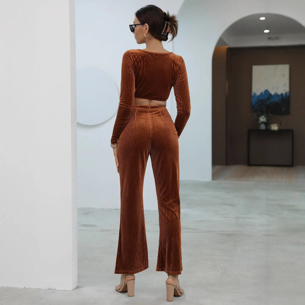 Caramel coloured women's long sleeve sweater and loose trouser co-ord set on a hanger